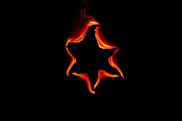 burning paper, glowing edge of paper on a black background