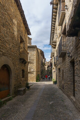 Fototapeta na wymiar Street with stone houses in the medieval village of Ainsa in the pyrenees, Aragon, Spain