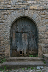 Fototapeta na wymiar old door in a street of medieval village Ainsa in the spanish pyrenees, Huesca, Aragon, Spain