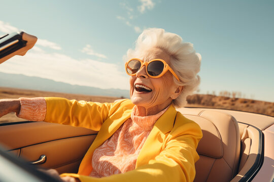 elderly woman in convertible - old lady driving car - happy retirement driving- woman driving in the desert - living life