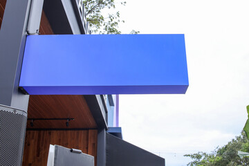 Blank rectangle store signage for mockup. Rectangle signboard hanging mounted on the green wall. Signboard for logo presentation. 
