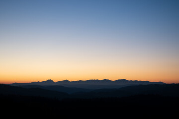 sunrise over the silhouette of the mountains