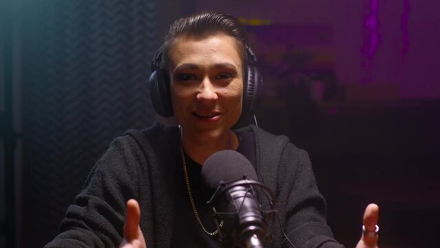 Portrait Girl androgyne is doing a podcast. A lesbian woman blogger in a professional studio, talks about happiness and freedom. A video blog about LGBT and transgender psychology. DJ on the radio