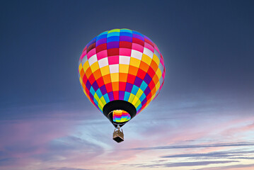 Fototapeta premium Colorful hot air balloon flying at sunset 