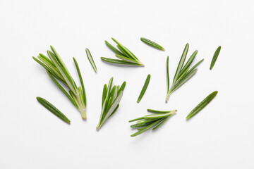 Sprigs of fresh rosemary on white background, flat lay