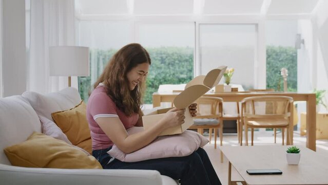 Asia people young Gen Z woman smile open unbox unpack parcel box goods carton packaging happy joy face. Omni channel enjoy buy gift order postal at retail online shop store send courier home service.