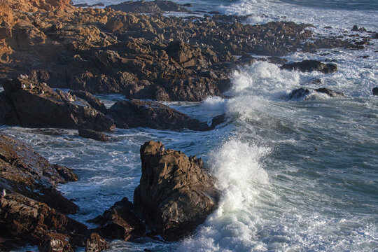 Crashing waves on rocky central California coastline at Cambria California United States