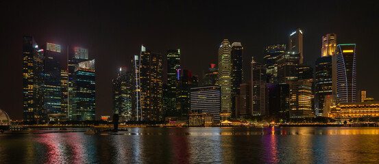 Fototapeta na wymiar Landscape view of Singapore business district and city night district dusk sky. Singapore cityscape at dusk building around Marina bay. Concept of Travel trip in asia cityscape landmark