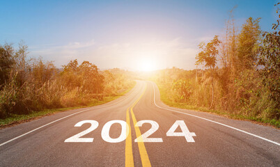 2024 written on highway road. Empty asphalt road and beautiful sunrise sky background. Concept of goal and challenge for vision new year 2024