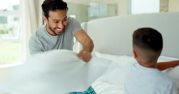 Pillow fight, happy dad and boy kid in bedroom with energy, funny games and joke together at home. Excited child, father and smile for freedom with pillows, crazy morning and quality time with family
