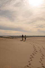 Two womens walks through the dunes of the Cabo Polonia National Park in the Department of Rocha in Uruguay