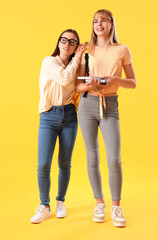 Female students on yellow background
