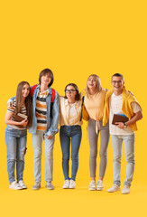 Fototapeta premium Group of teenage students on yellow background