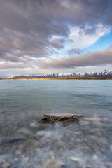 Scenic sunrise view of Lake Pukaki, with their mesmerizing turquoise hue and reflect the majestic snow-capped Southern Alps. Perfect for travel brochures, nature magazines, and inspirational content.