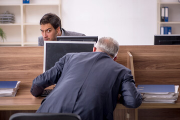 Two male colleagues working in the office