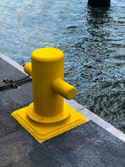 Yellow color bollard on the dock - 623945724