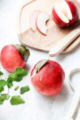Peaches (nectarines) on a white stone background