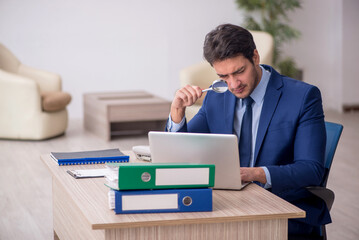 Young male employee working in the office