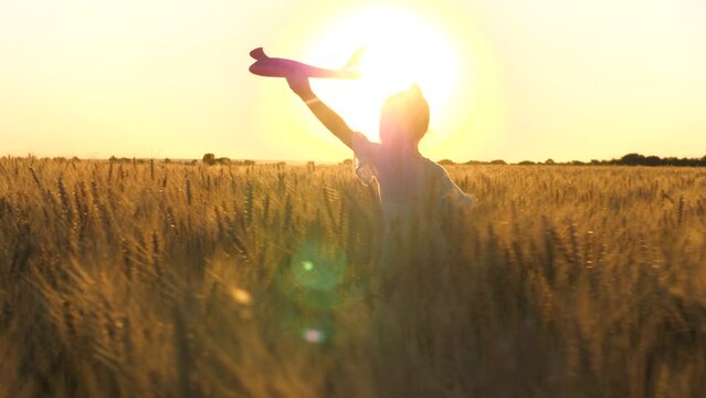 little child girl daughter runs through wheat field with toy plane her hand sunset, happy family dream fly, child dreams becoming astronaut pilot pilot sky, go everywhere, cheerful child with toy