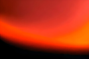 Vibrant red orange color gradient on black background, grainy gradient luminous color wave