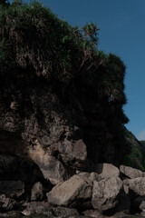 Large natural rocks block a mountain stream