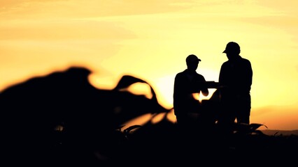 Fototapeta na wymiar silhouette two farmers work tablet sunset, farming teamwork group people contract handshake agreement sunset corn wheat, inspecting landscape collaboration shaking farmers computer agronomists hands