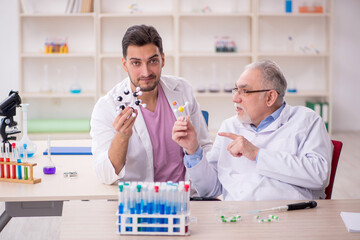 Two male chemists working at the lab