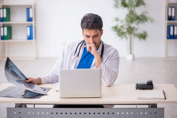 Fototapeta premium Young male doctor radiologist working in the clinic