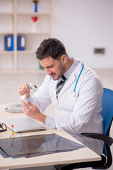 Young male doctor working at the hospital