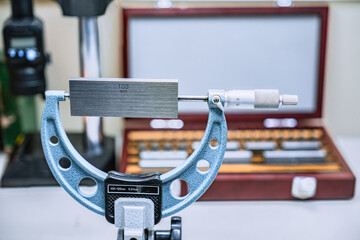 Micrometer Calibration with gauge block in laboratory factory.