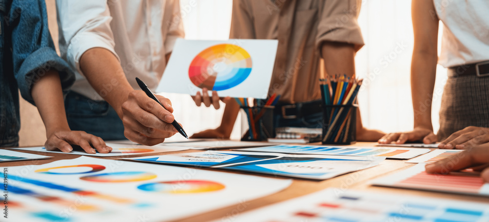 Aufkleber Graphic designer brainstorm logo and graphic art at busy creative studio workshop. Experiment and brainstorm color palette and pattern at workspace table for creative design. Panorama shot. Scrutinize