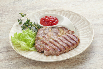 Grilled pork neck steak with ketchup