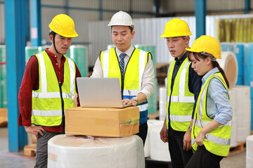 Group of technician engineer and businessman in protective uniform standing and discussing, researching, brainstorming and planning work together with computer at industry manufacturing factory