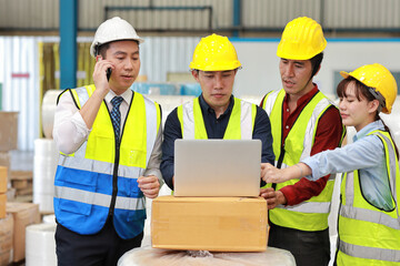 Group of technician engineer and businessman in protective uniform standing and discussing, researching, brainstorming and planning work together with computer at industry manufacturing factory