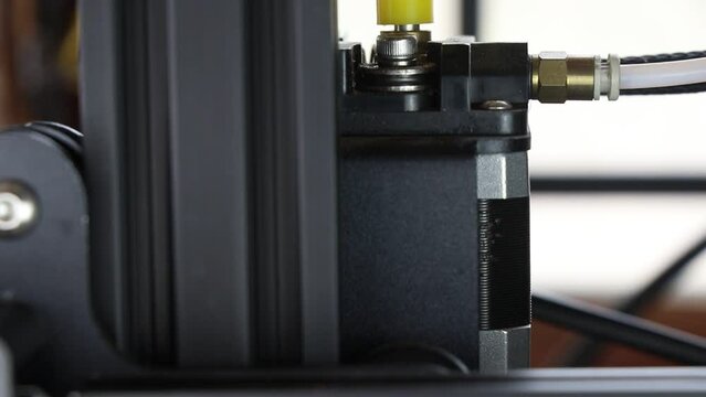3D Printer parts view of a filament feeding stepper motor. Stepper motor shaft movement on a 3d printing machine