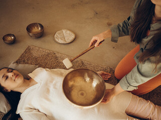 Music Meditation Session in a Studio. Bronze music bowls, body healing procedure. Magic vibrations...