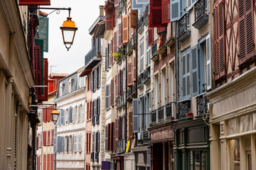 Obraz premium Main street of Bayonne with very picturesque architecture and colorful shuttered windows, France.