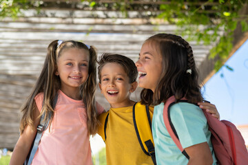 Portrait, Friends And Children Standing Together In A Row Outdoors, Feeling Happy While Having Fun Or Playing. Group Of Classmates Who Smile And Hug Each Other. Back To School And Education