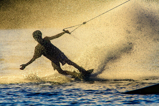 wakeboarder on a lake, waterski cable lift