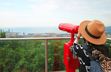 Female Traveler Enjoy Aerial View of Black Sea with Binoculars on the Observation Deck of  Batumi,...