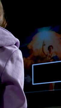 girl teenager young woman sits in front of a computer and a screen saver before the start of the movie Lilac blouse sit near 