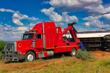 highway accident, red tow truck pulling a bus from the side of the road