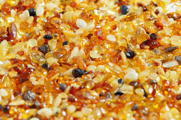 Natural gemstone amber texture background, stones yellow orange gradient color. Natural mineral material for jewelry. Amber textured Aesthetic sunstones wallpaper, pieces ancient resin