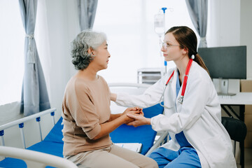Fototapeta premium Friendly Female Head Nurse Making Rounds does Checkup on Patient Resting in Bed. She Checks tablet while Man Fully Recovering after Successful Surgery in hospital.