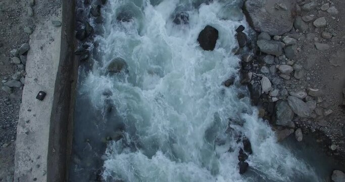 Beautiful river of Gilgit baltistan Pakistan drone footage of beautiful river flowing producing white foam rotatory motion footage 