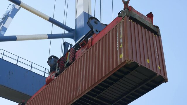 4K actual cam footage of crane port lifting down red container on cargo trailer stock video. 