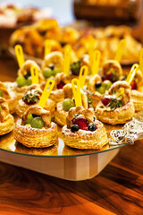 Puff Pastry Fruit Tarts with Yogurt Pastry Cream, finger food, kids birthday party, on a rustic wooden table