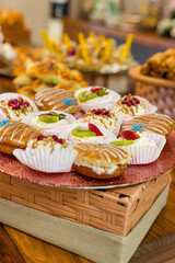 doughnuts and fruit tarts with wiped cream and glazed with chocolate and fondant , kids birthday party