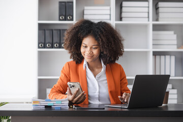 Success and excited young African American woman sitting in creative office, Excited businesswoman or winner celebrate winning. 