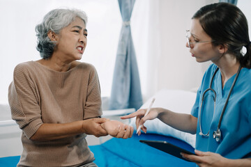 Physical injury treatment: Serious doctors are analyzing fracture patients. elderly with broken arm talking to trauma doctor or orthopedic surgeon during physical examination in hospital or clinic.